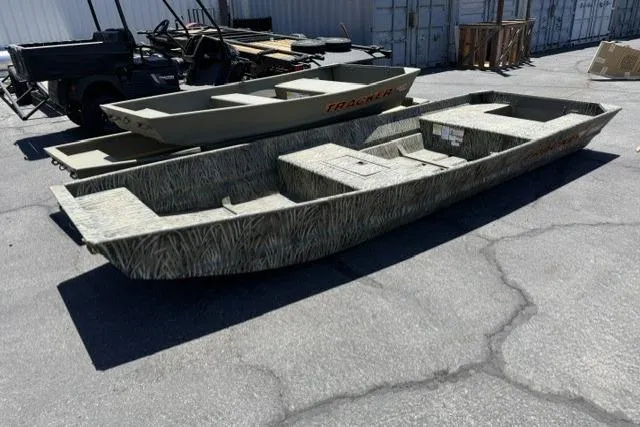 The Image of 2026 Tracker Grizzly 15 Jon boat, camo design, parked outdoors on concrete surface. - 0