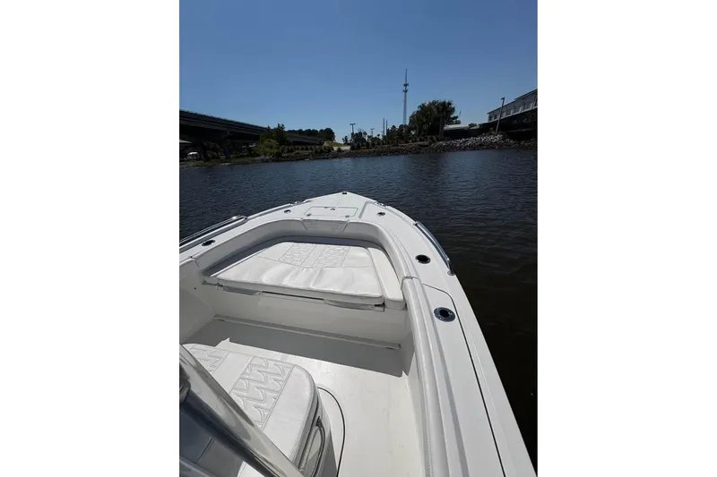 Slide: The Image of 2026 Parker 180 Coastal boat on calm water under clear blue sky. - 13