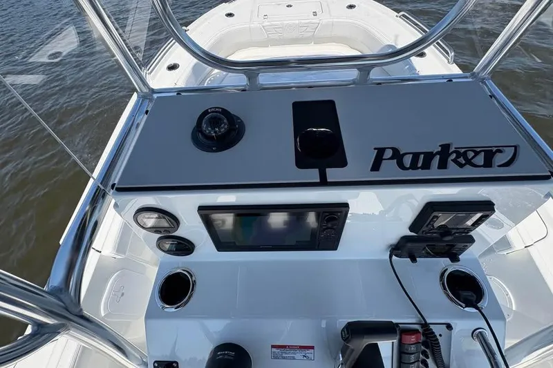 Slide: The Image of 2026 Parker 180 Coastal boat dashboard with navigation equipment and controls. - 18