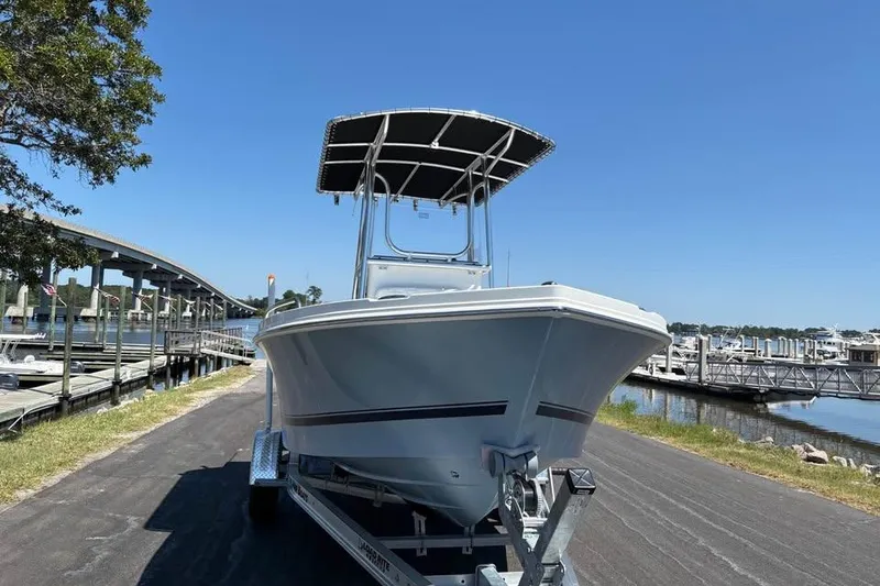 Slide: The Image of 2026 Parker 180 Coastal boat on trailer by marina under clear blue sky. - 3
