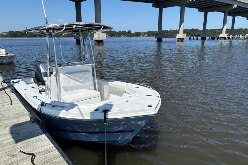 Slide: The Image of 2026 Parker 180 Coastal boat docked by a bridge on a sunny day. - 7