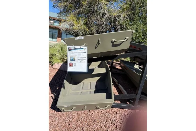 Slide: The Image of 2026 Tracker Grizzly 12 Jon boat displayed outdoors on a stand. - 2