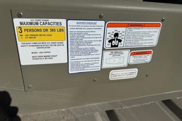 Slide: The Image of 2026 Tracker Grizzly 12 Jon boat capacity and safety warning labels. - 4