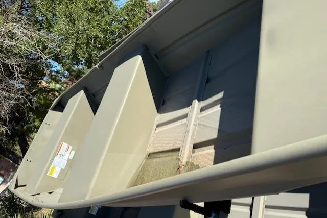 Slide: The Image of 2026 Tracker Grizzly 12 Jon boat interior with bench seats and open deck. - 5
