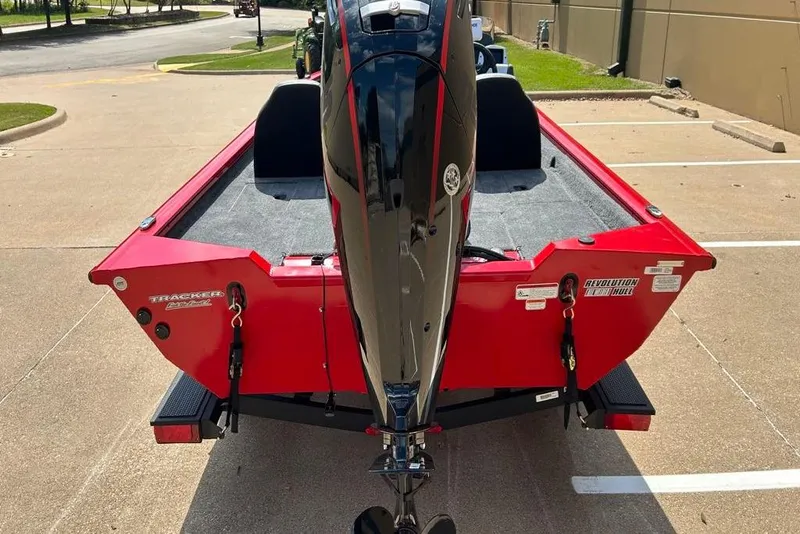 Slide: The Image of 2026 Tracker Pro Team 190 boat with red exterior and powerful outboard motor. - 11