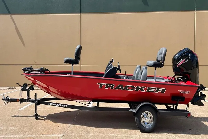 Slide: The Image of 2026 Tracker Pro Team 190 boat, red, on trailer, parked outdoors. - 13