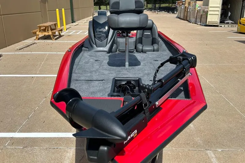 Slide: The Image of 2026 Tracker Pro Team 190 boat with red exterior and gray interior, parked outdoors. - 14