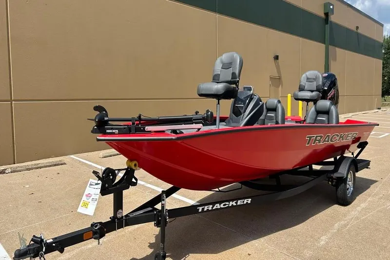 Slide: The Image of 2026 Tracker Pro Team 190 boat in vibrant red on a trailer, parked outdoors. - 15