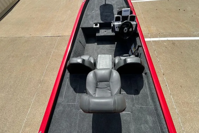 Slide: The Image of 2026 Tracker Pro Team 190 boat interior with gray seating and red trim. - 5