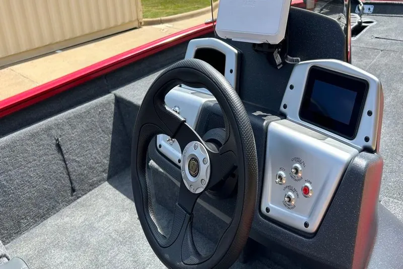 Slide: The Image of 2026 Tracker Pro Team 190 boat dashboard with steering wheel and control panel. - 8