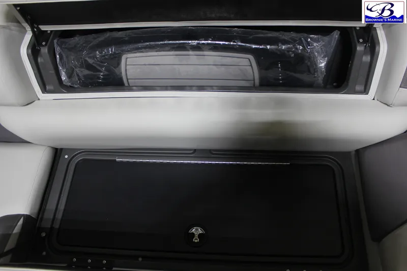 Slide: The Image of 2026 Sun Tracker Fishin' Barge 22 DLX storage compartment interior view. - 13