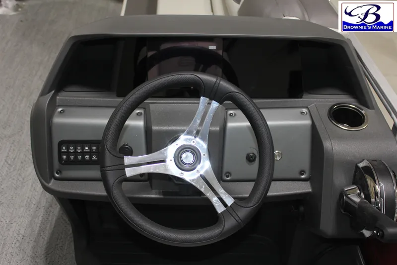 Slide: The Image of Steering console of 2026 Sun Tracker Fishin' Barge 22 DLX with modern controls. - 17
