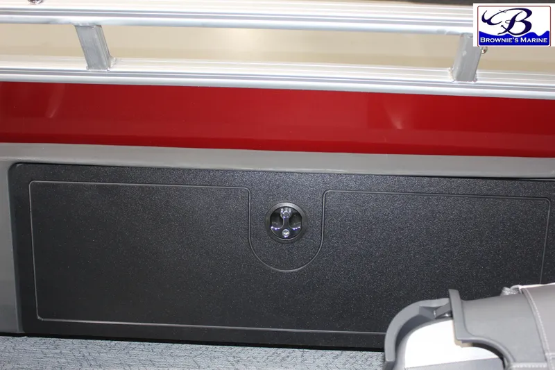 Slide: The Image of 2026 Sun Tracker Fishin' Barge 22 DLX storage compartment with red and black design. - 20
