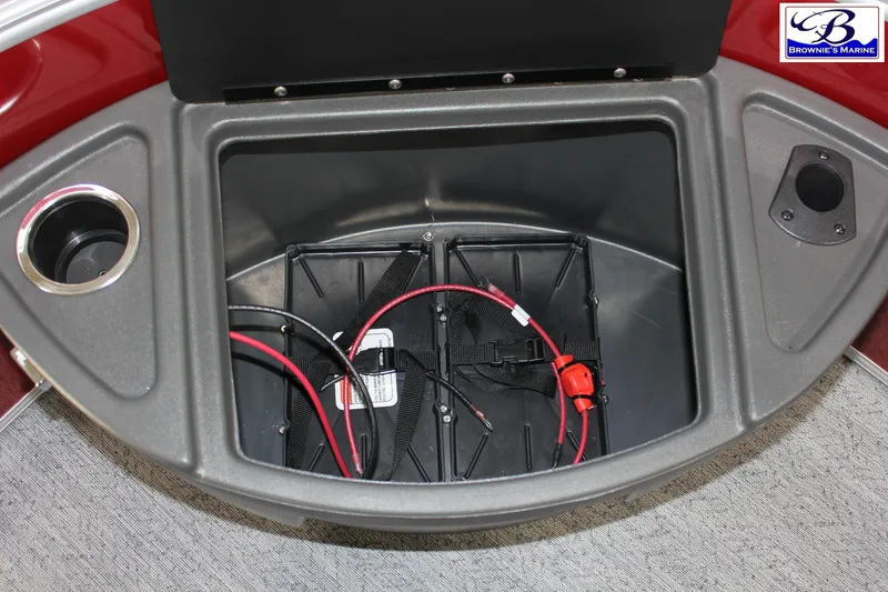 Slide: The Image of 2026 Sun Tracker Fishin' Barge 22 DLX storage compartment with wiring and cup holder. - 7