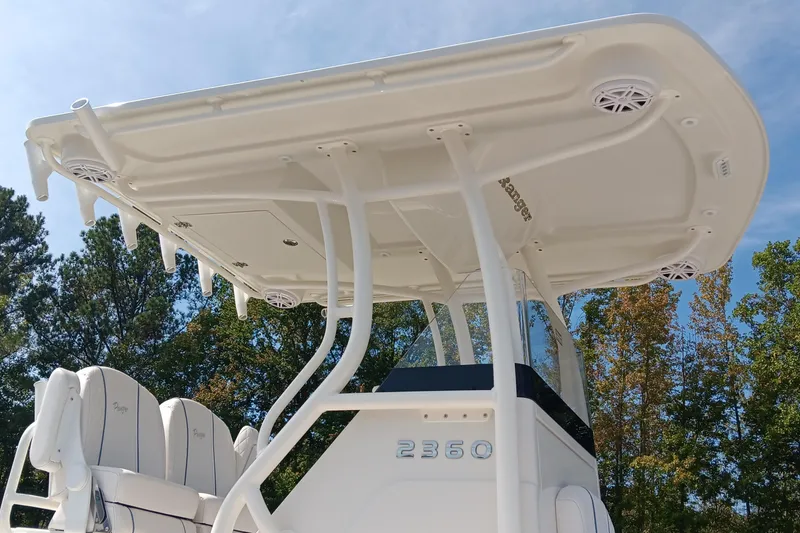 Slide: The Image of 2026 Ranger 2360 Bay boat with T-top and seating, set against a clear sky. - 11
