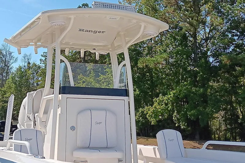 Slide: The Image of 2026 Ranger 2360 Bay boat with T-top, surrounded by trees. - 13