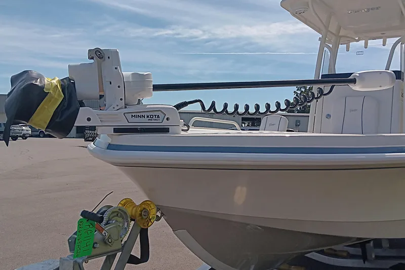 Slide: The Image of 2026 Ranger 2360 Bay boat with Minn Kota motor, parked outdoors. - 15