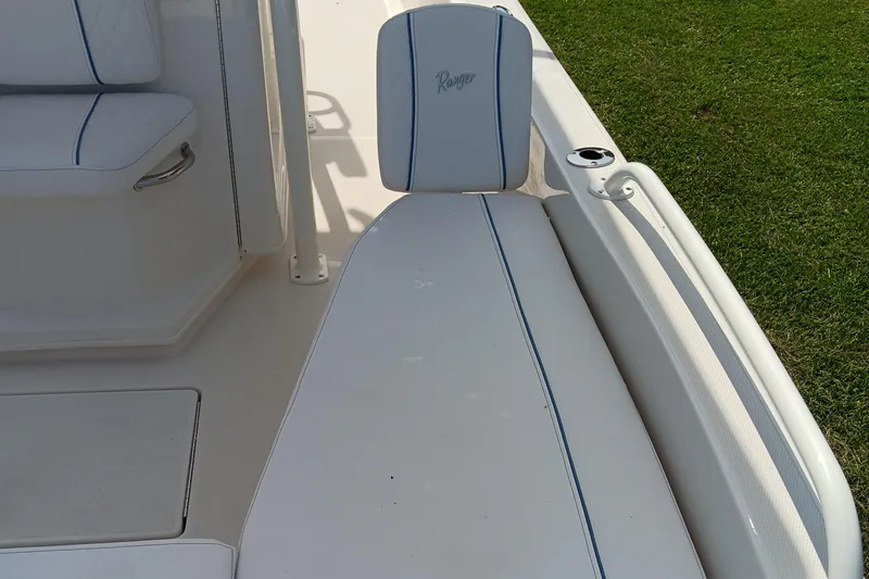 Slide: The Image of 2026 Ranger 2360 Bay boat interior with white cushioned seating and blue accents. - 22