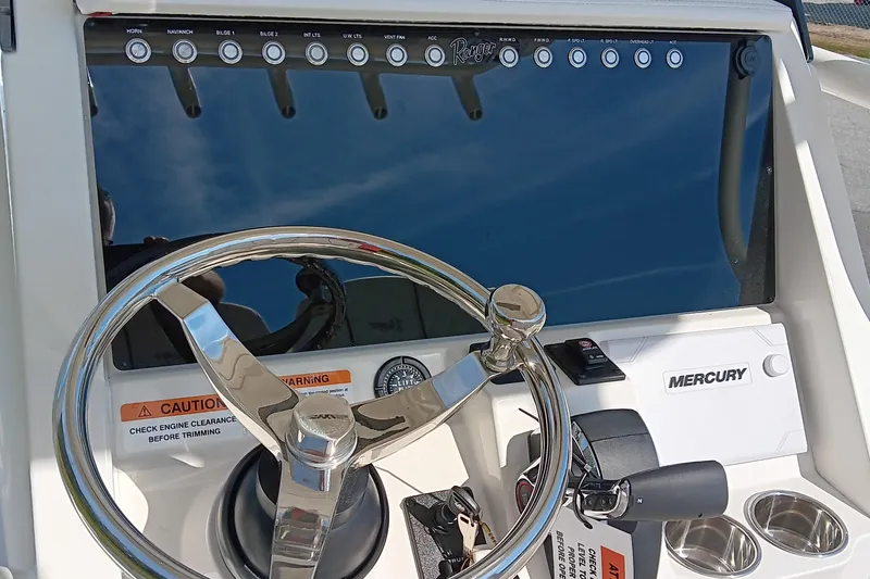 Slide: The Image of 2026 Ranger 2360 Bay boat dashboard with steering wheel and Mercury controls. - 25