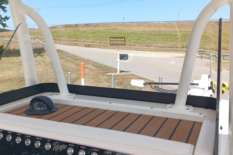 Slide: The Image of 2026 Ranger 2360 Bay boat dashboard with road view in the background. - 27
