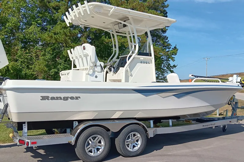 Slide: The Image of 2026 Ranger 2360 Bay boat on trailer, parked outdoors, side view. - 3