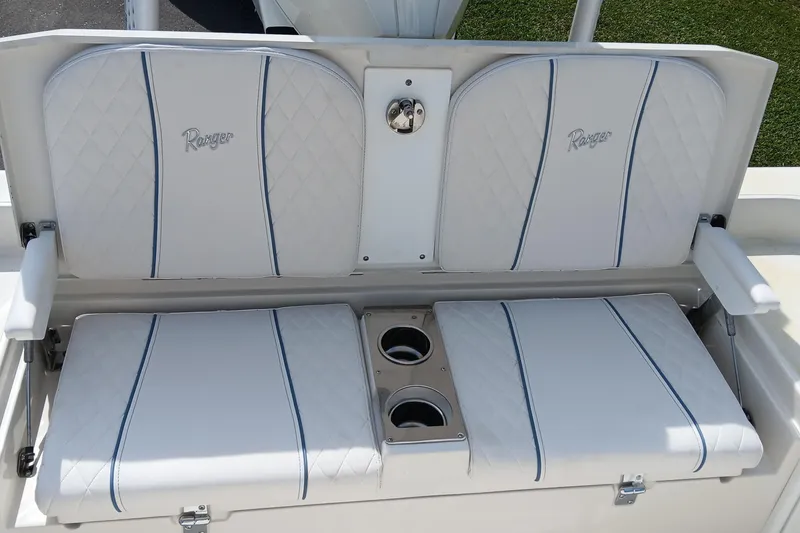 Slide: The Image of 2026 Ranger 2360 Bay boat seating with cup holders, featuring white and blue upholstery. - 30