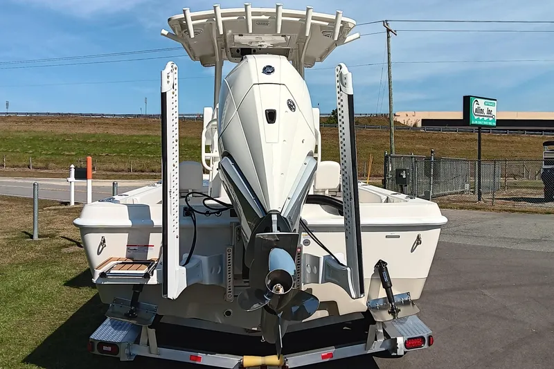Slide: The Image of 2026 Ranger 2360 Bay boat on trailer, rear view, outdoor setting. - 4