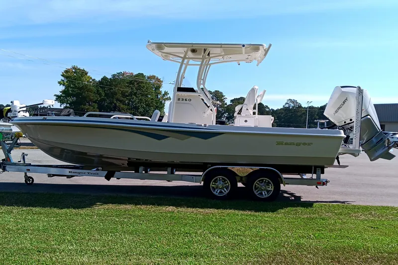 Slide: The Image of 2026 Ranger 2360 Bay boat on trailer, parked outdoors, side view. - 6