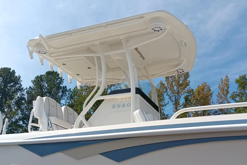 Slide: The Image of 2026 Ranger 2360 Bay boat with T-top, viewed from below against a clear sky. - 8