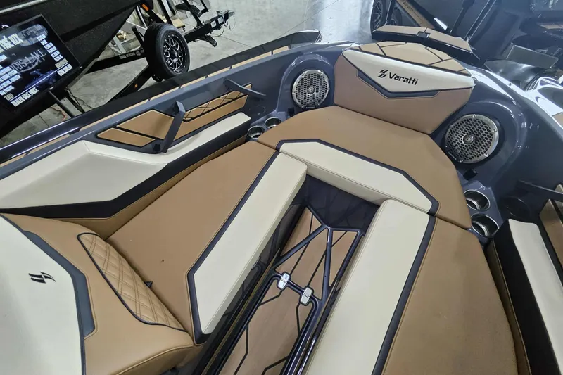 Slide: The Image of 2024 Varatti Z2272 boat interior with tan and cream seating, featuring speakers and cup holders. - 11