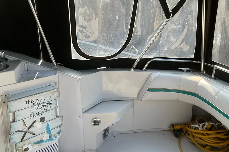 Slide: The Image of Interior of 1992 Wellcraft 3400 Gran Sport boat with seating and nautical decor. - 10