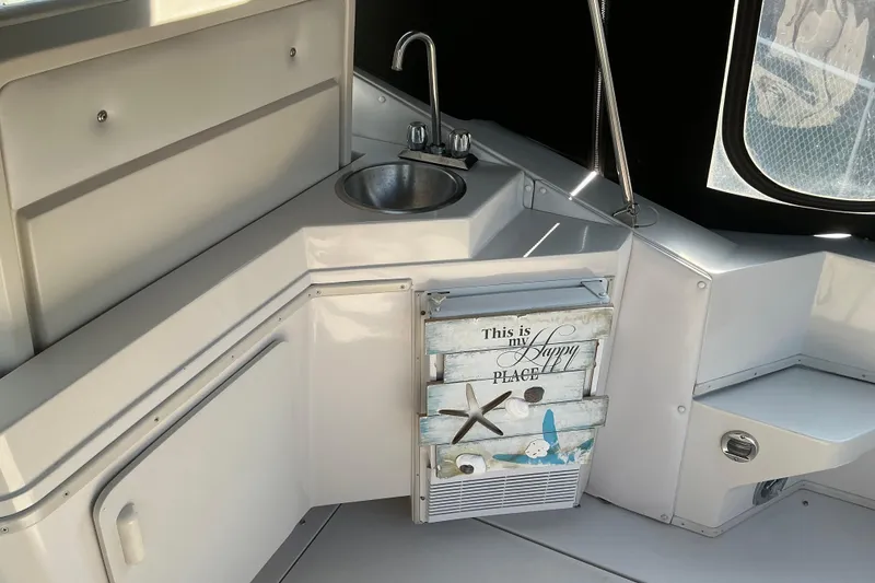 Slide: The Image of Interior of a 1992 Wellcraft 3400 Gran Sport boat with sink and decorative panel. - 11