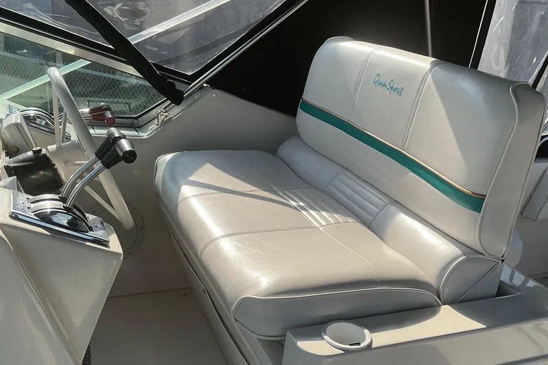 Slide: The Image of 1992 Wellcraft 3400 Gran Sport boat interior with white leather seating and steering controls. - 15