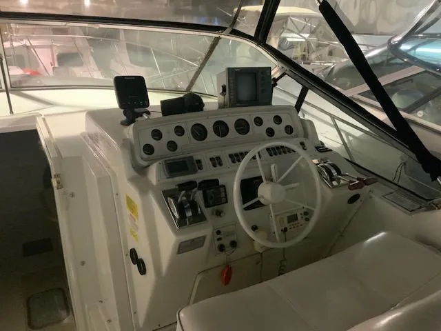 Slide: The Image of 1992 Wellcraft 3400 Gran Sport boat cockpit with steering wheel and control panel. - 16