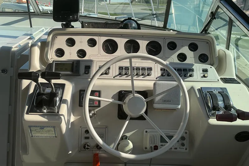 Slide: The Image of Cockpit of 1992 Wellcraft 3400 Gran Sport boat with steering wheel and control panel. - 17