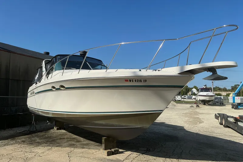 Slide: The Image of 1992 Wellcraft 3400 Gran Sport boat on dry dock under clear blue sky. - 2