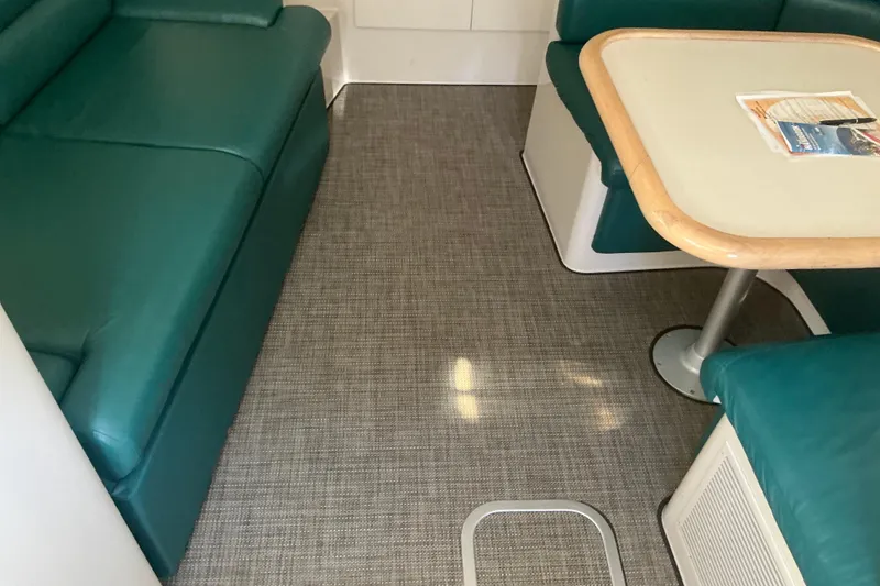 Slide: The Image of Interior of 1992 Wellcraft 3400 Gran Sport with green seating and table. - 20