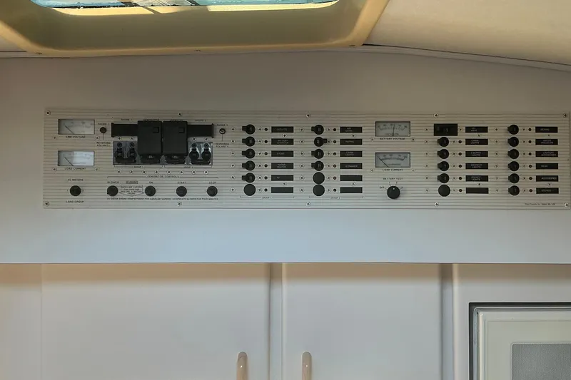 Slide: The Image of Control panel of a 1992 Wellcraft 3400 Gran Sport boat, featuring various switches and gauges. - 25