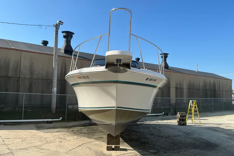 Slide: The Image of 1992 Wellcraft 3400 Gran Sport boat on dry dock, industrial background, clear sky. - 3