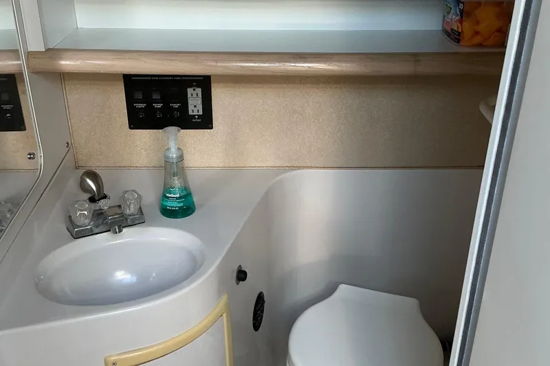 Slide: The Image of 1992 Wellcraft 3400 Gran Sport bathroom with sink, faucet, and toilet. - 31