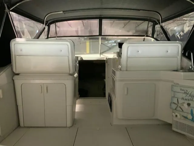 Slide: The Image of 1992 Wellcraft 3400 Gran Sport boat interior with white seating and storage cabinets. - 7
