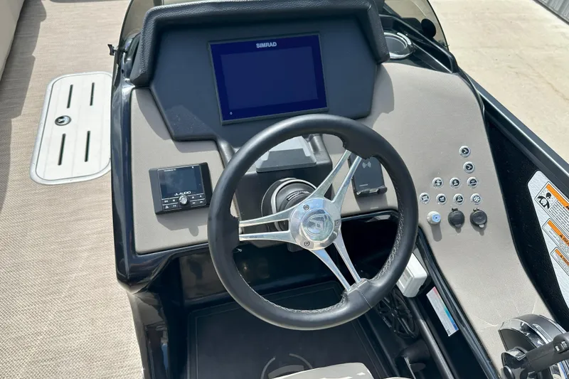 Slide: The Image of Steering console of 2021 Premier 250 Solaris RE boat with Simrad display and controls. - 10