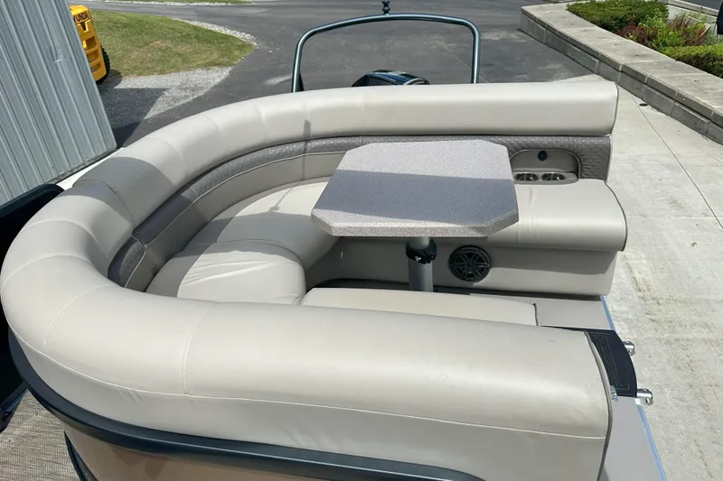 Slide: The Image of 2021 Premier 250 Solaris RE boat seating area with table, featuring beige upholstery. - 12