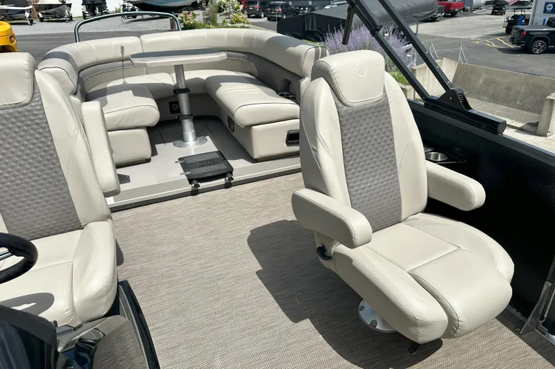 Slide: The Image of Luxurious seating on 2021 Premier 250 Solaris RE pontoon boat, featuring plush beige upholstery. - 6