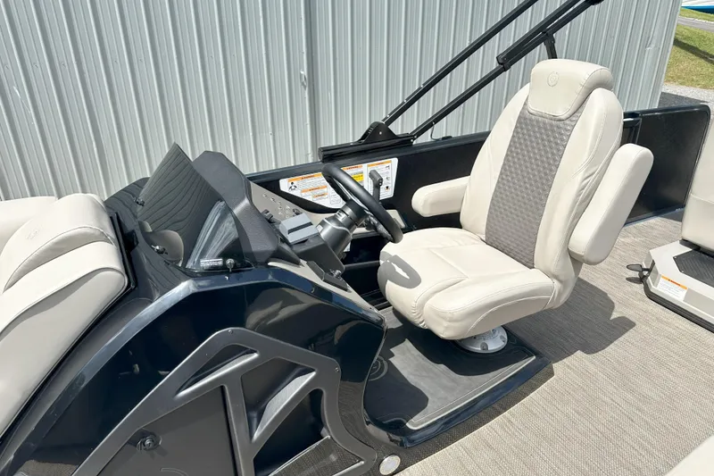 Slide: The Image of 2021 Premier 250 Solaris RE boat interior with captain's chair and steering console. - 7