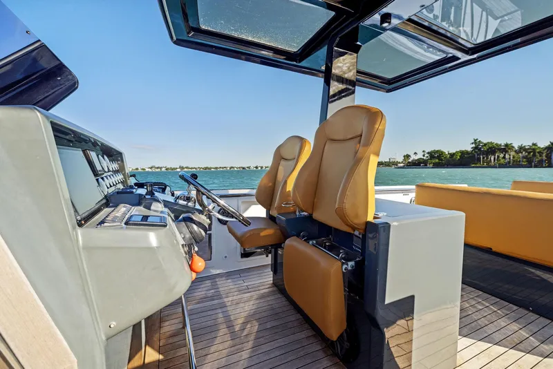 Slide: The Image of 2011 Fjord 40 Open boat interior with tan seats and modern dashboard. - 10