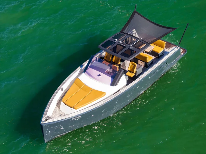 Slide: The Image of 2011 Fjord 40 Open yacht with sleek design and sunshade, cruising on vibrant green water. - 2