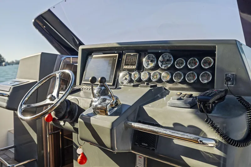 Slide: The Image of Control panel of a 2011 Fjord 40 Open boat with steering wheel and gauges. - 23