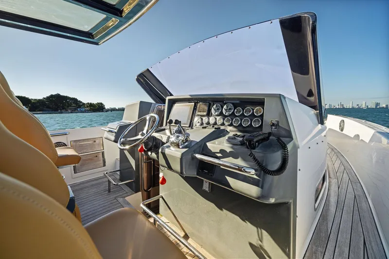 Slide: The Image of Fjord 40 Open 2011 yacht cockpit with steering wheel and control panel, on calm water. - 24