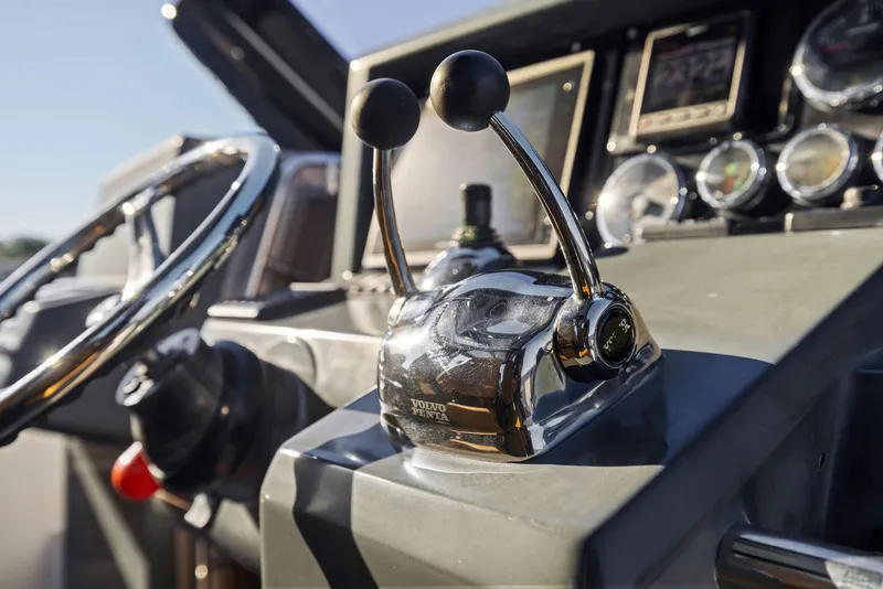 Slide: The Image of Control panel of a 2011 Fjord 40 Open boat with throttle levers and steering wheel. - 27